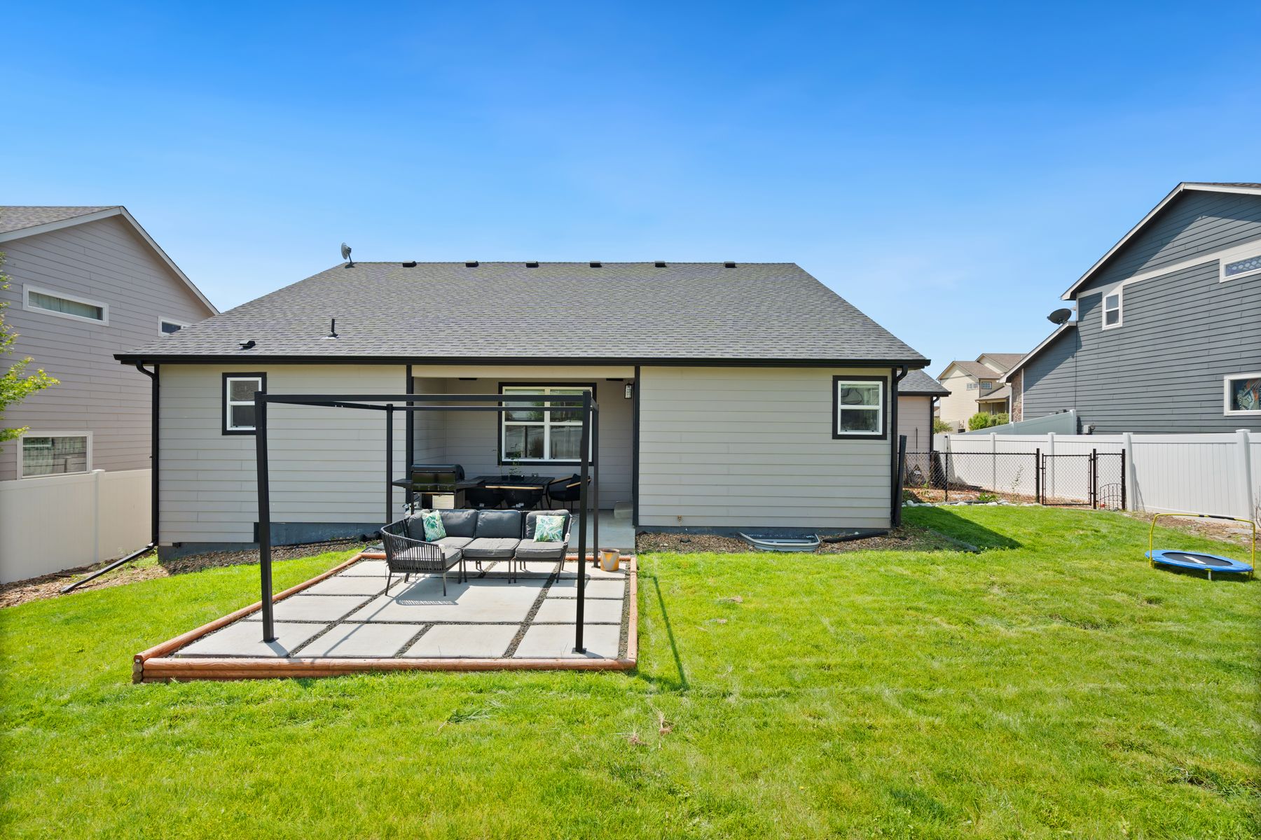 A clean residential backyard with a green lawn